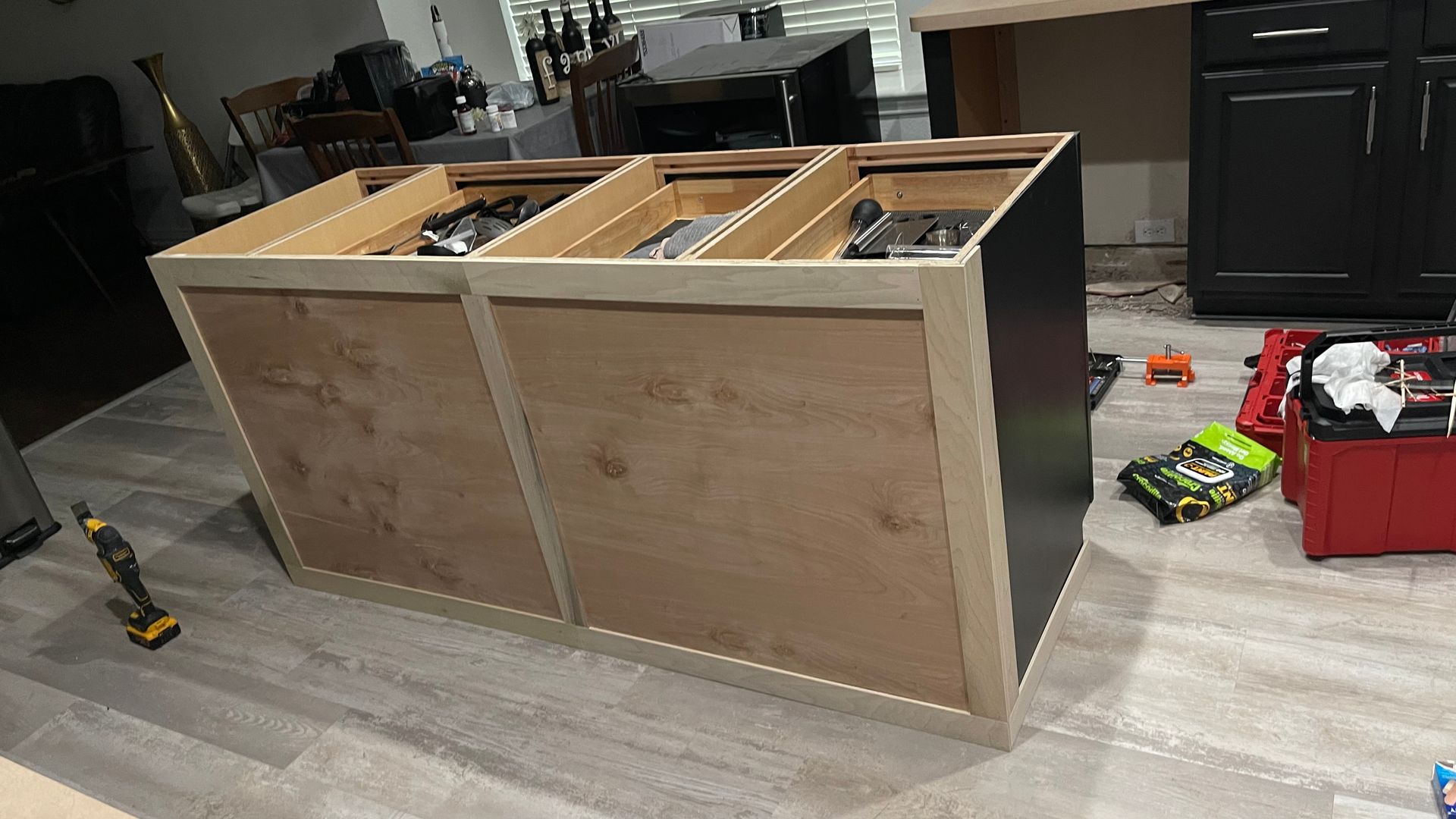 A wooden cabinet is being built in a living room.