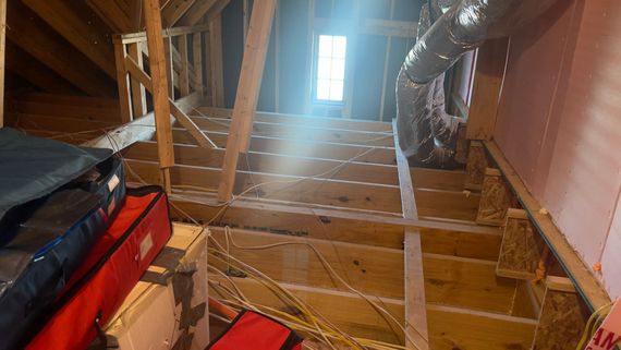 There is a light coming through the window in the attic.