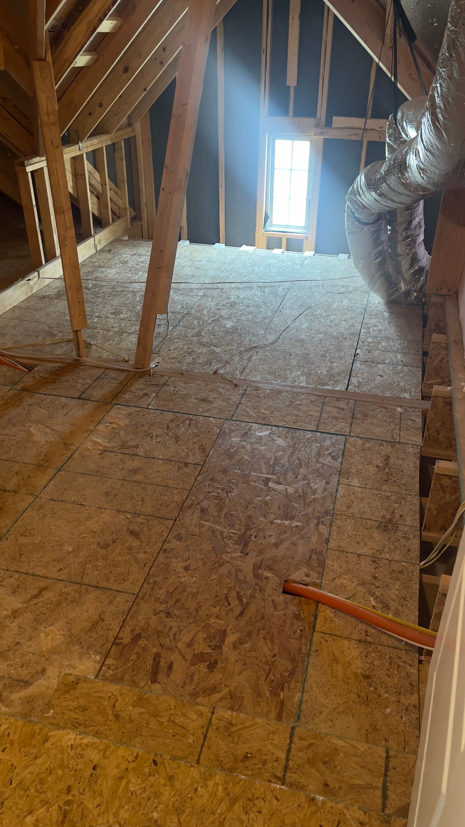 There is a window in the attic that is being built.