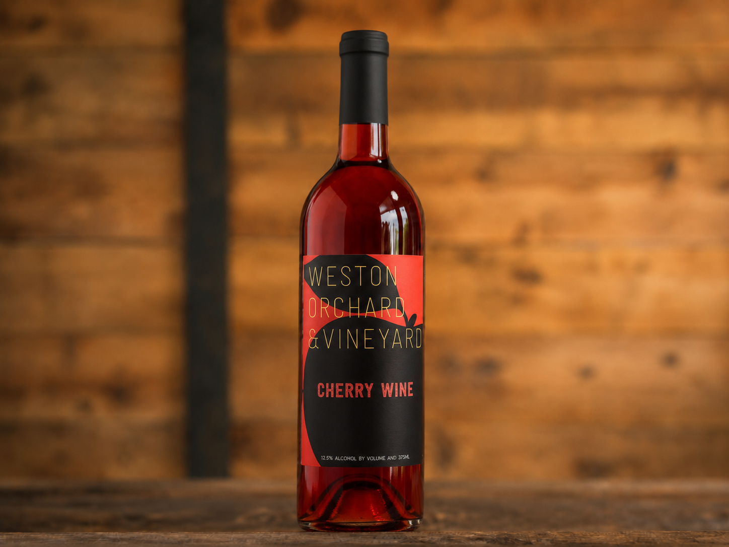 Three bottles of weston vineyard wine are on a table
