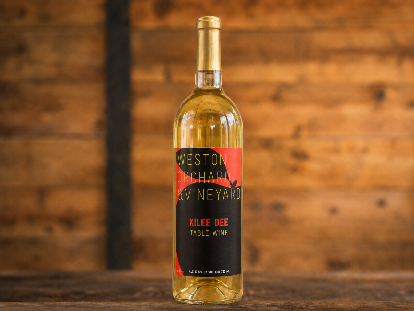 Three bottles of weston vineyard wine are on a table