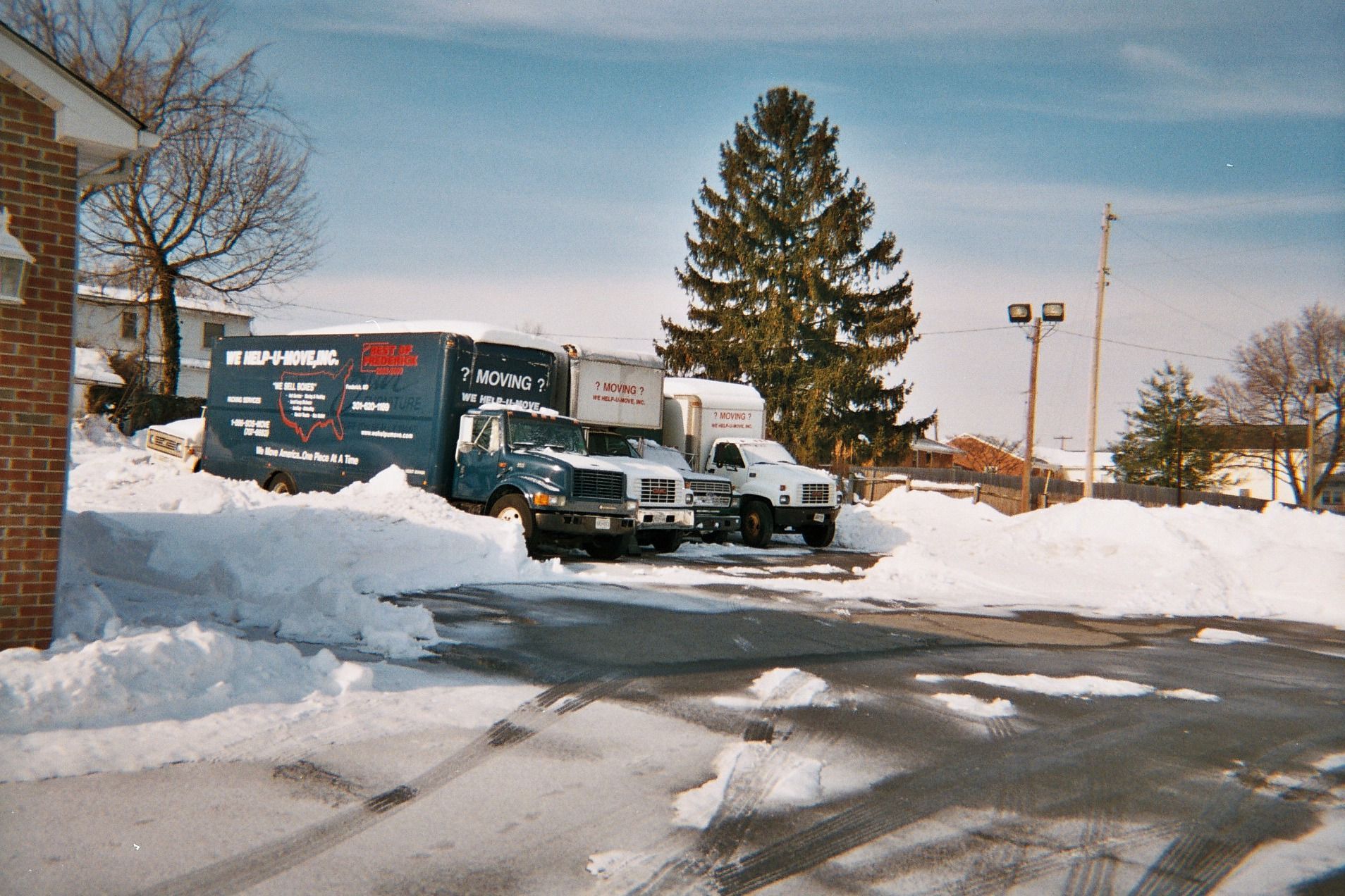 Moving company advertisement with white vans, text: