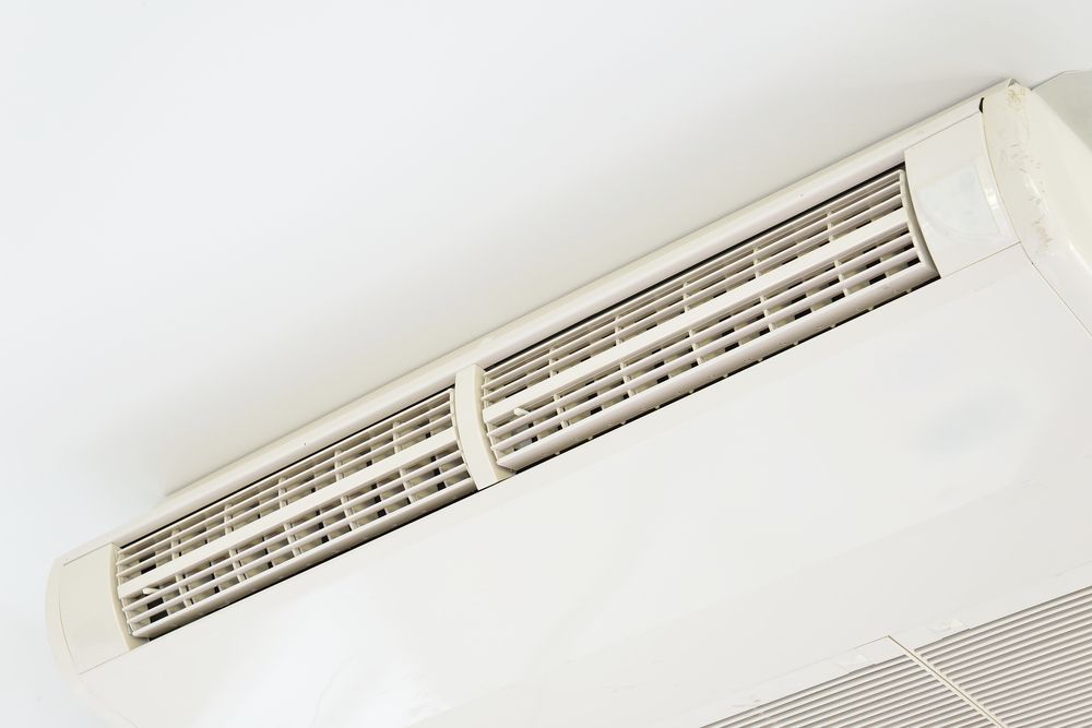 White air conditioner unit mounted on a white ceiling in Nowra