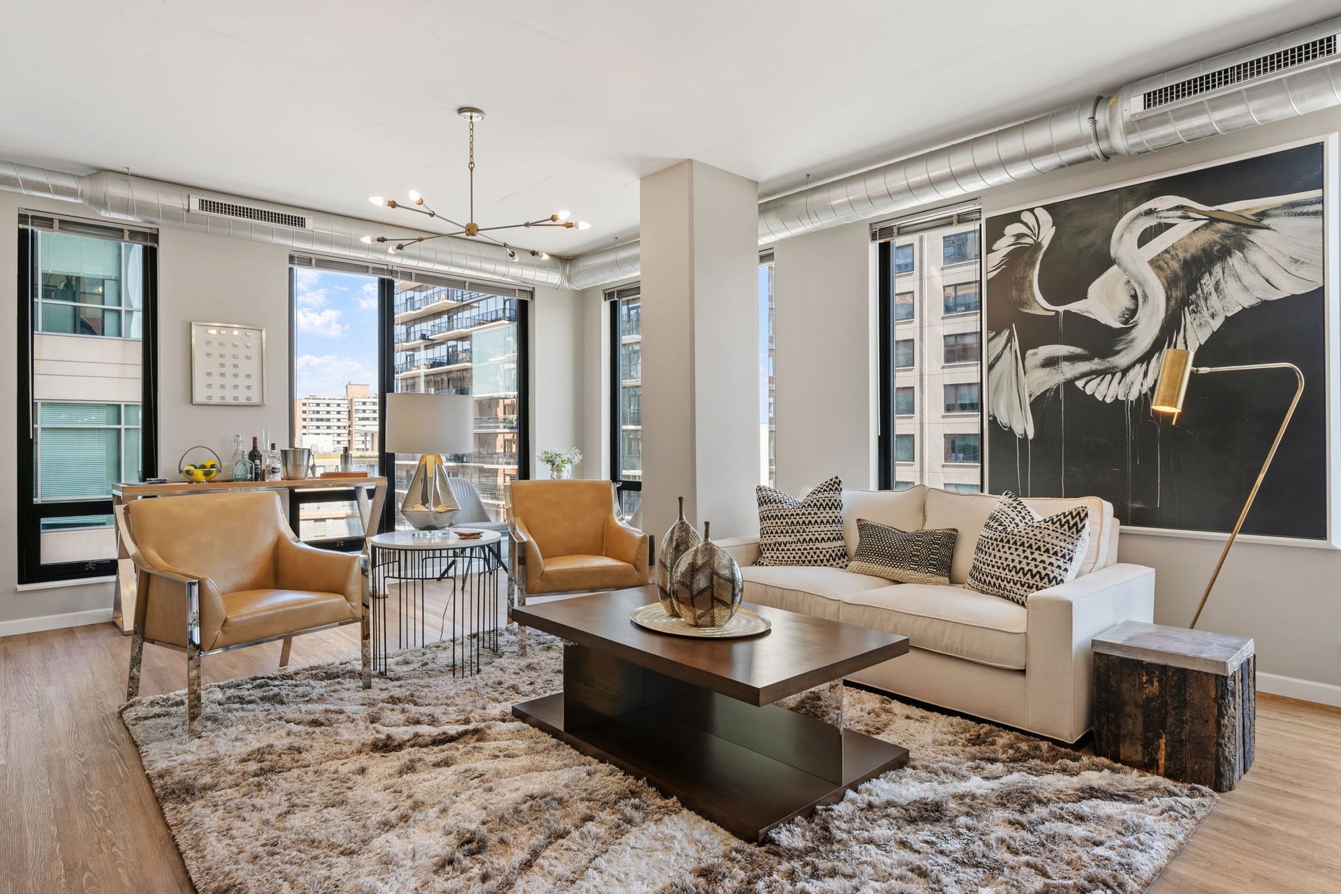 A living room with a couch , chairs and a coffee table