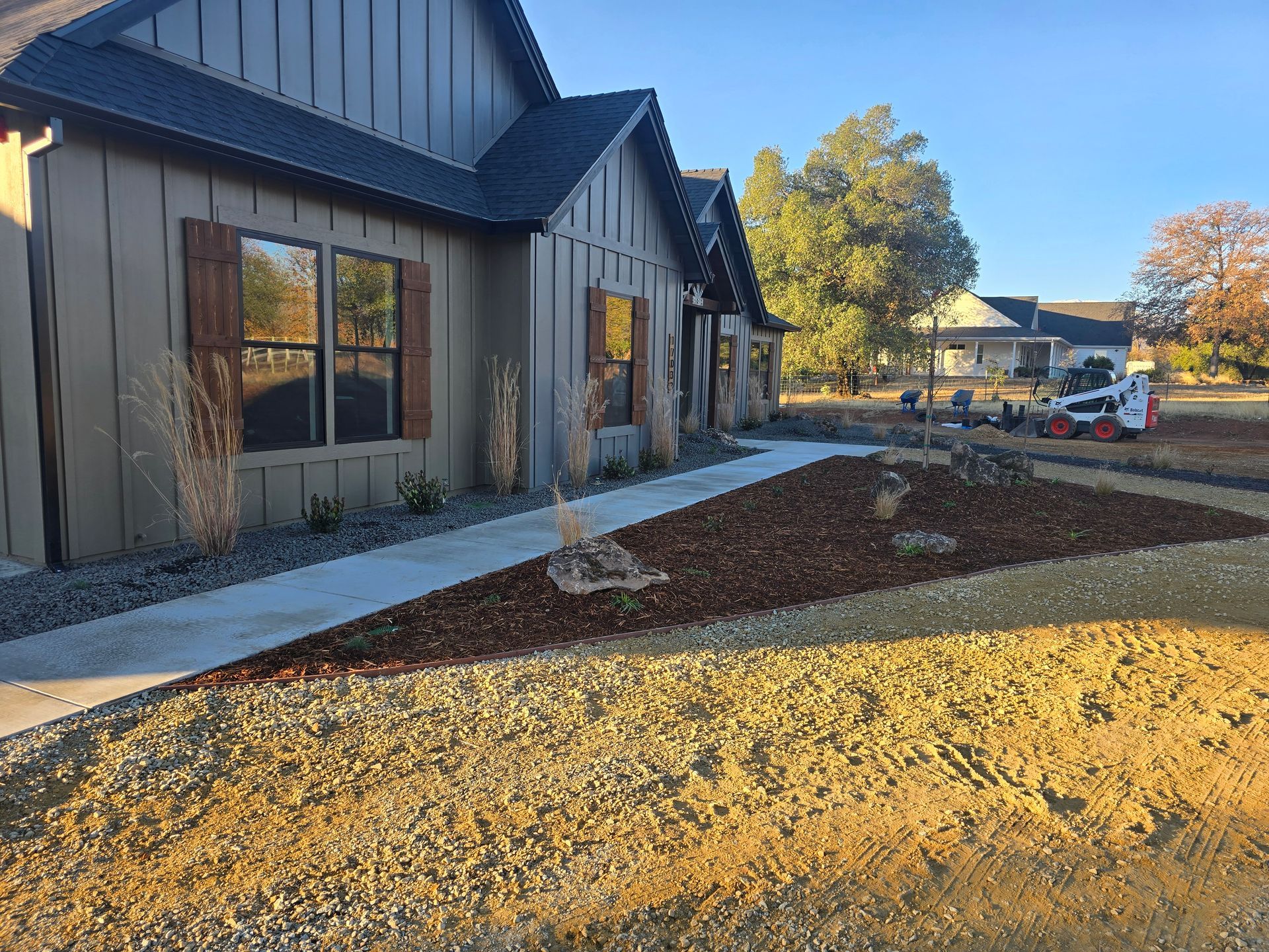 A house with a lot of gravel in front of it.