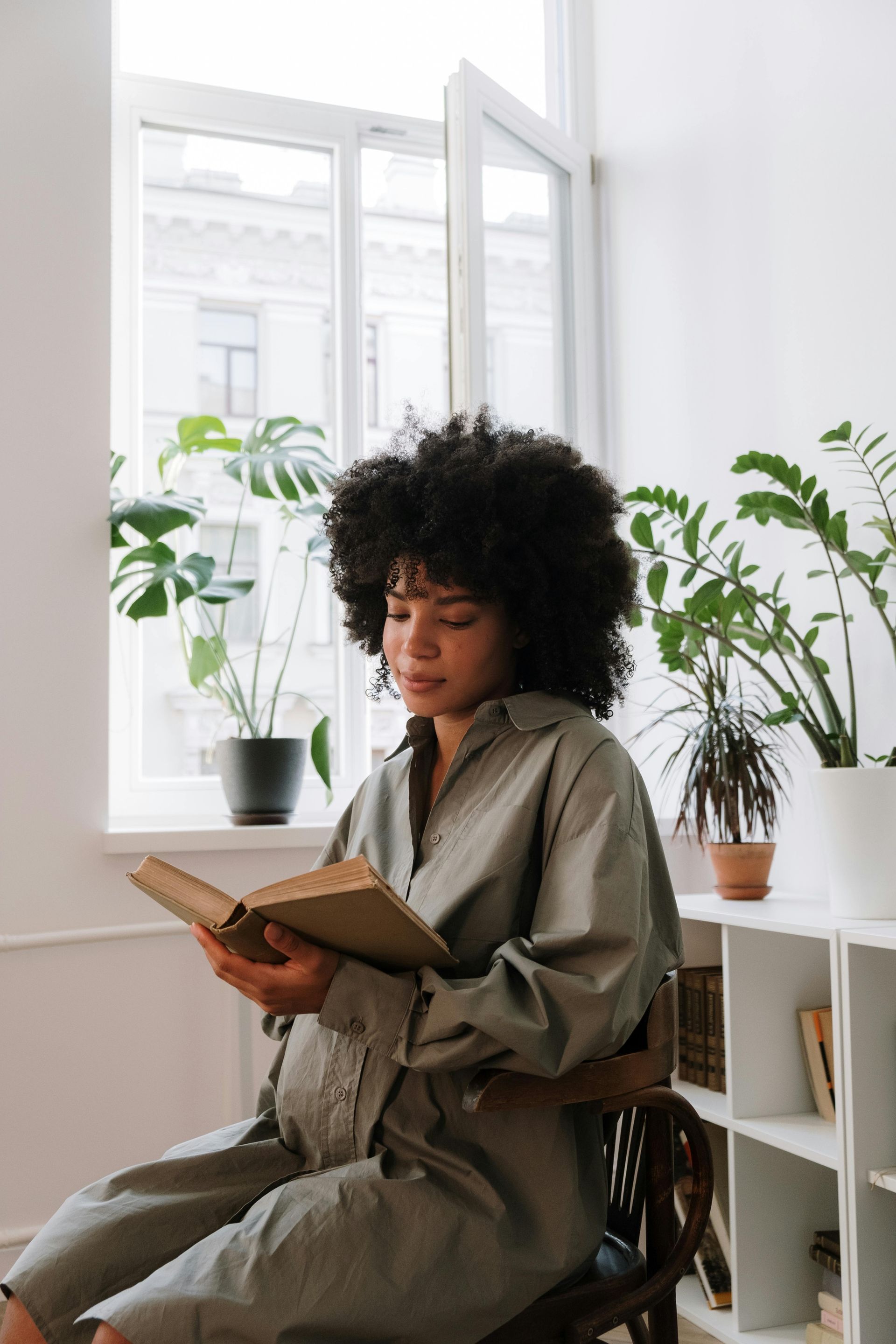Pregnant woman reading at home, reflecting on her journey with calm, support, and hope