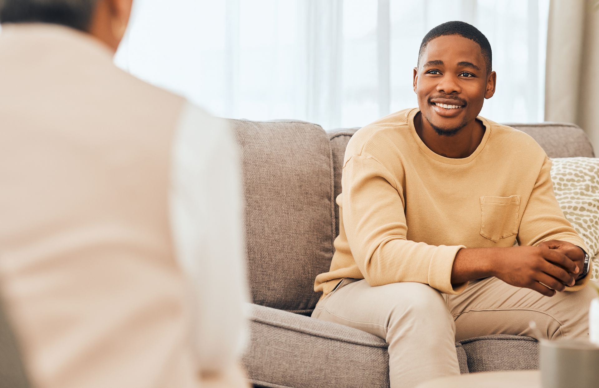 Man in supportive counseling session, receiving guidance in a safe and confidential setting