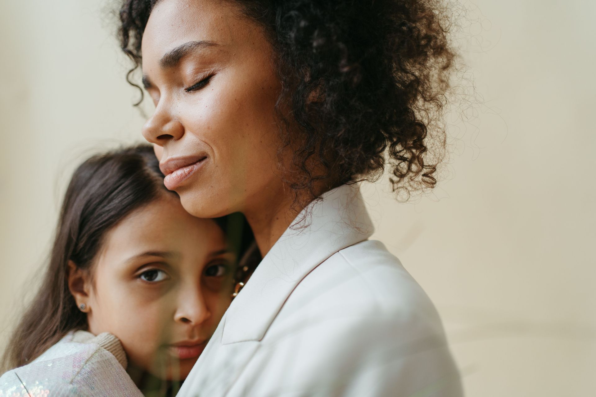 A parent holds a child close in a protective embrace