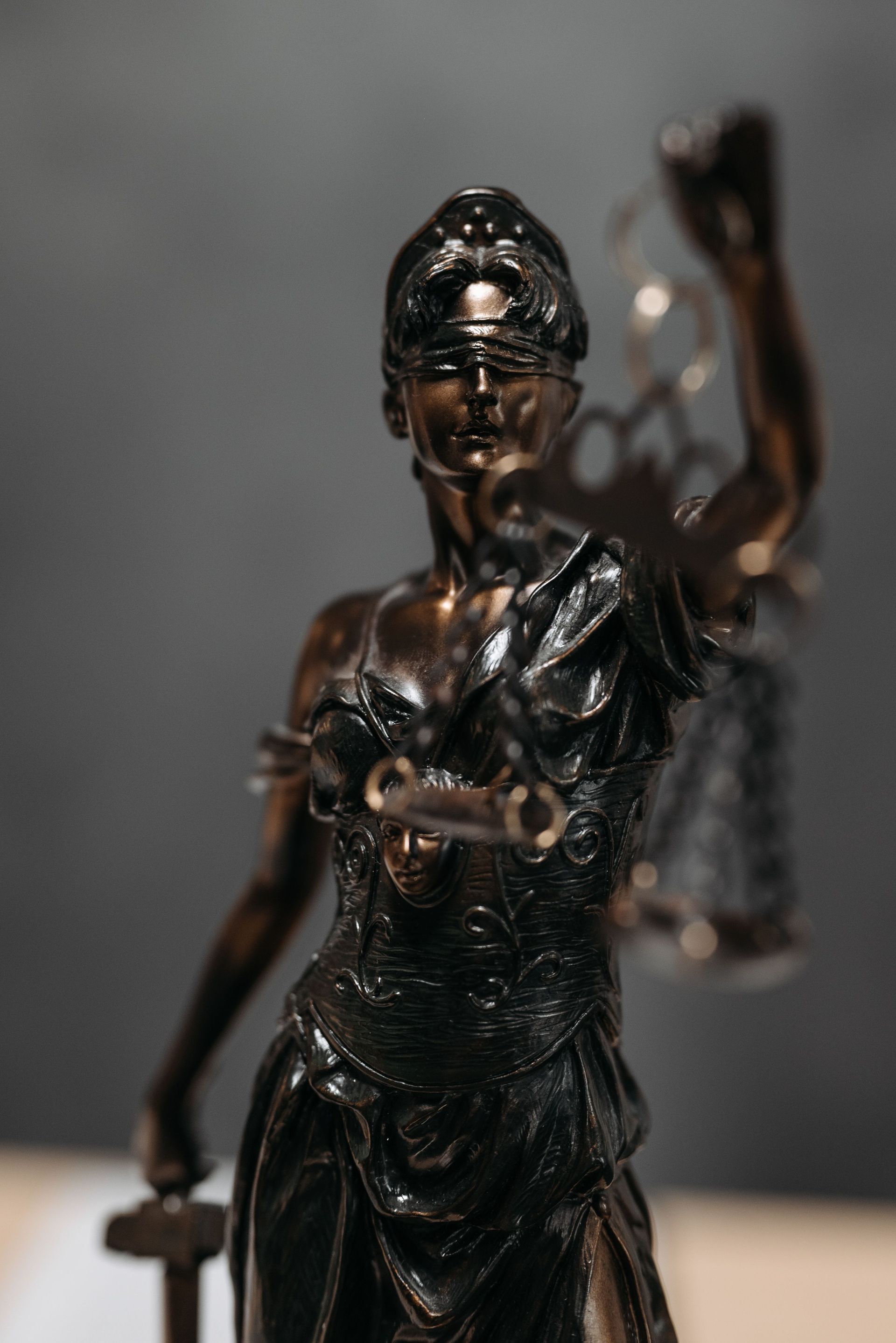 Bronze statue of the scales of justice, symbolizing fair and balanced representation
