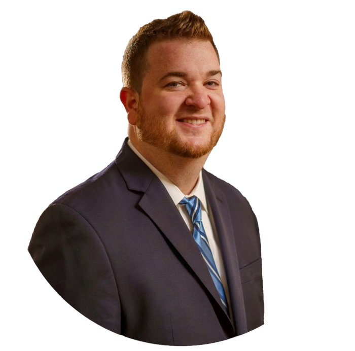 Man in navy suit and tie smiling.