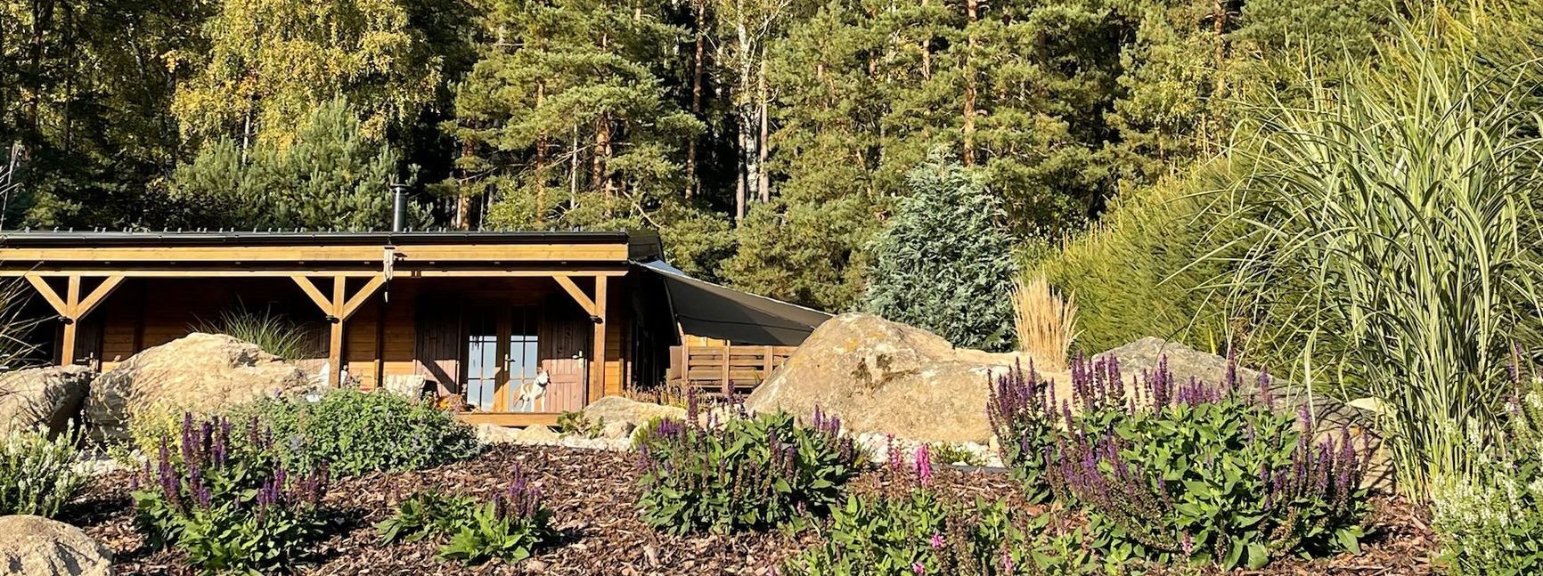 Wooden structure surrounded by plants and trees.