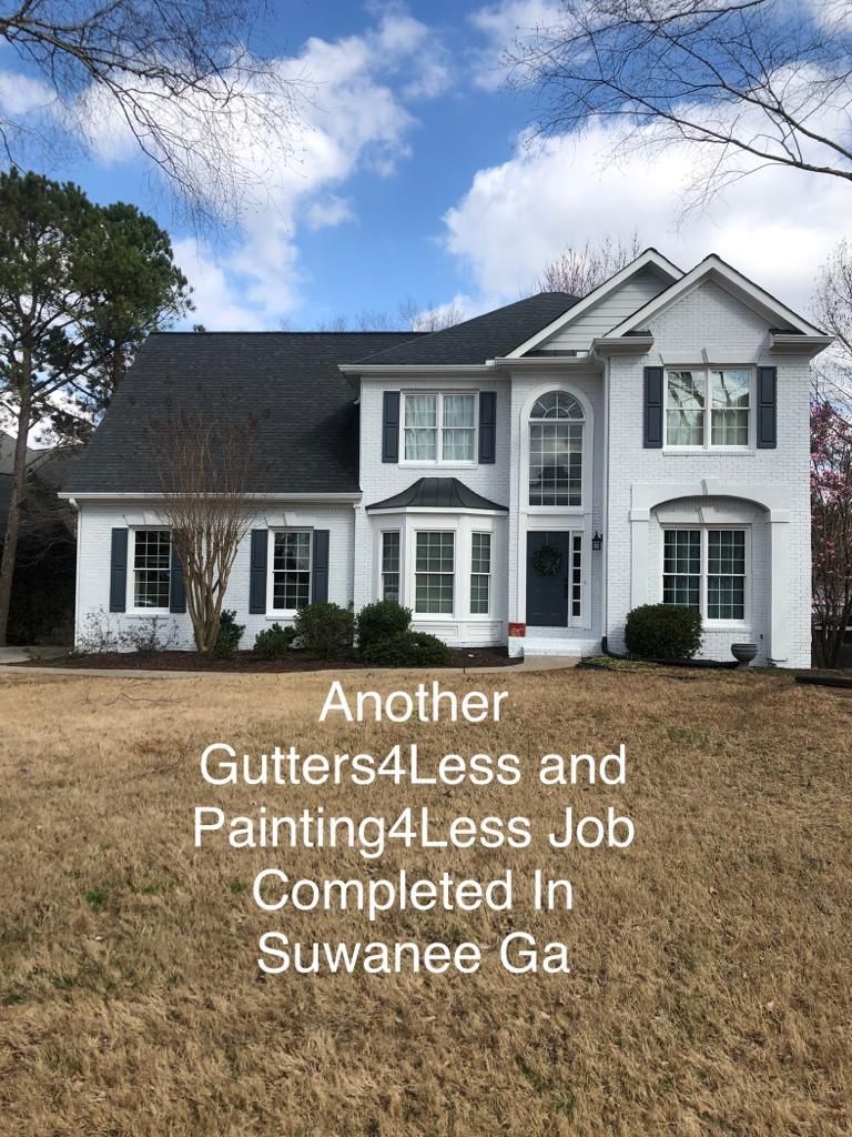 A white two-story brick house with dark shutters and roof, featuring text about a completed home improvement job in Suwanee.