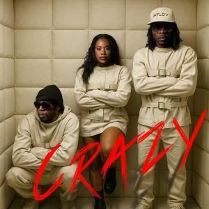 Three people in beige outfits pose against a padded wall with “CRAZY” written in red.