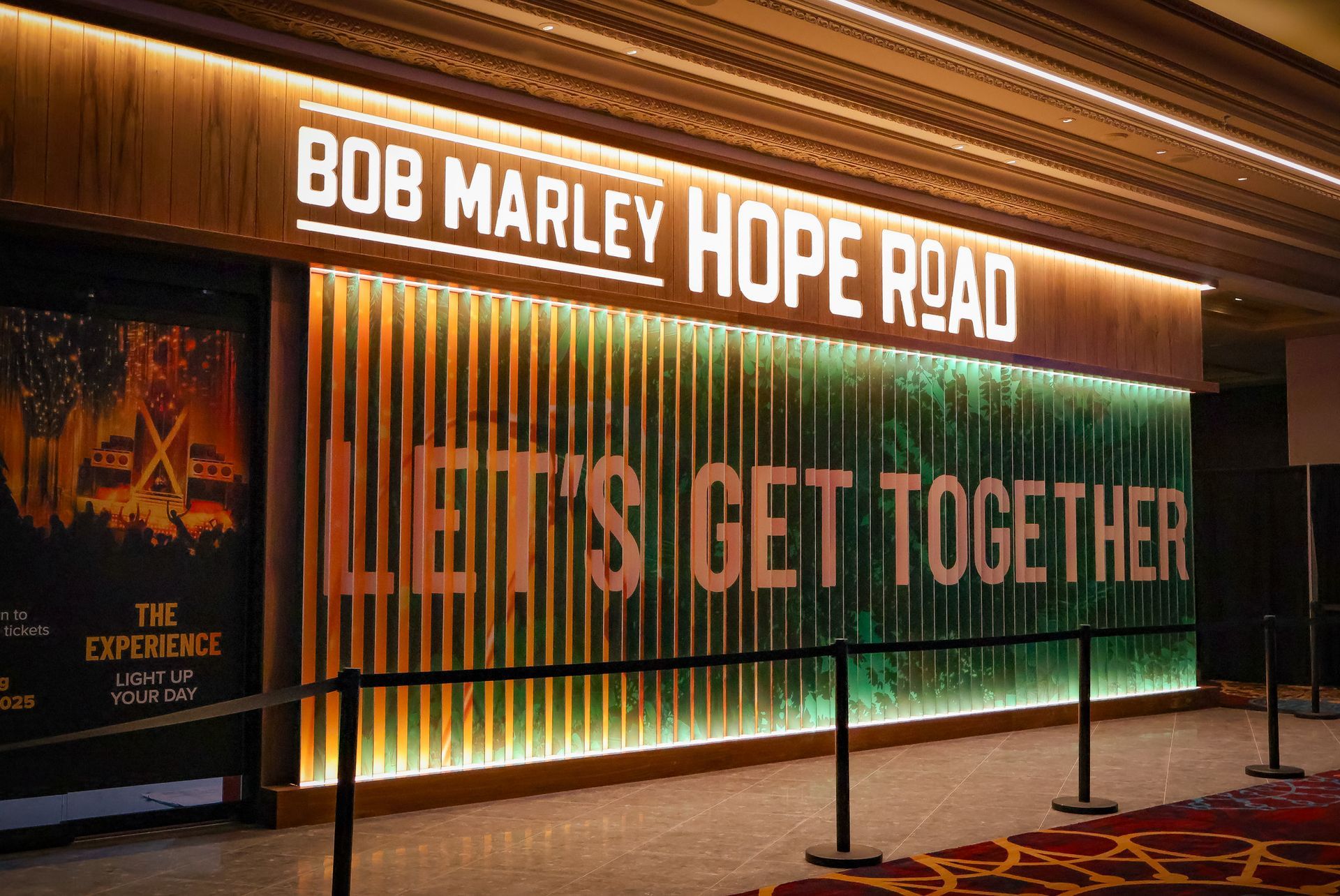 Entrance sign for Bob Marley Hope Road with large “Let’s Get Together” lettering