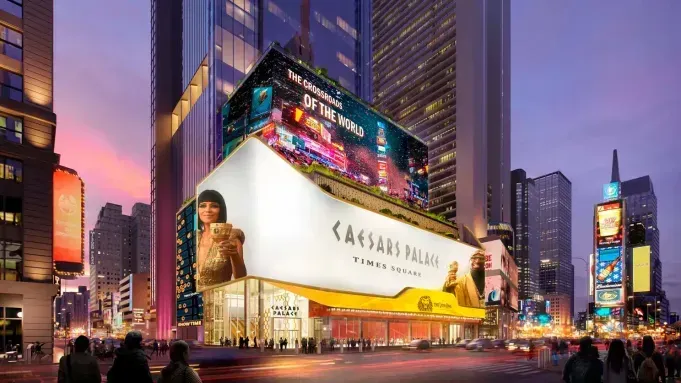 Times Square at dusk with bright billboards, tall buildings, and pedestrians on the street.