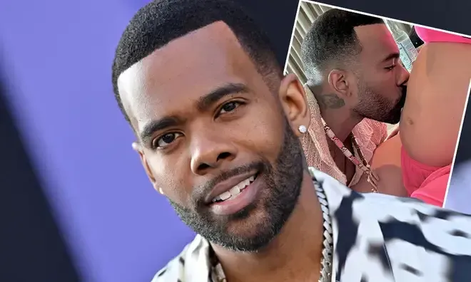 Smiling man in a white-and-black jacket with a small inset of him kissing someone on a pink background
