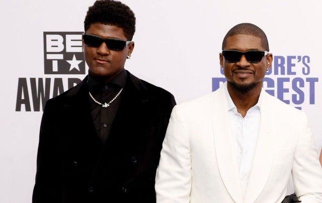 Two men in black and white suits wearing sunglasses on a BET Awards red carpet