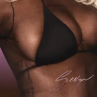 Close-up of a person in a black bikini top with a signature watermark in the corner