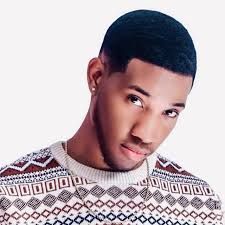 Portrait of a man in a patterned sweater against a white background