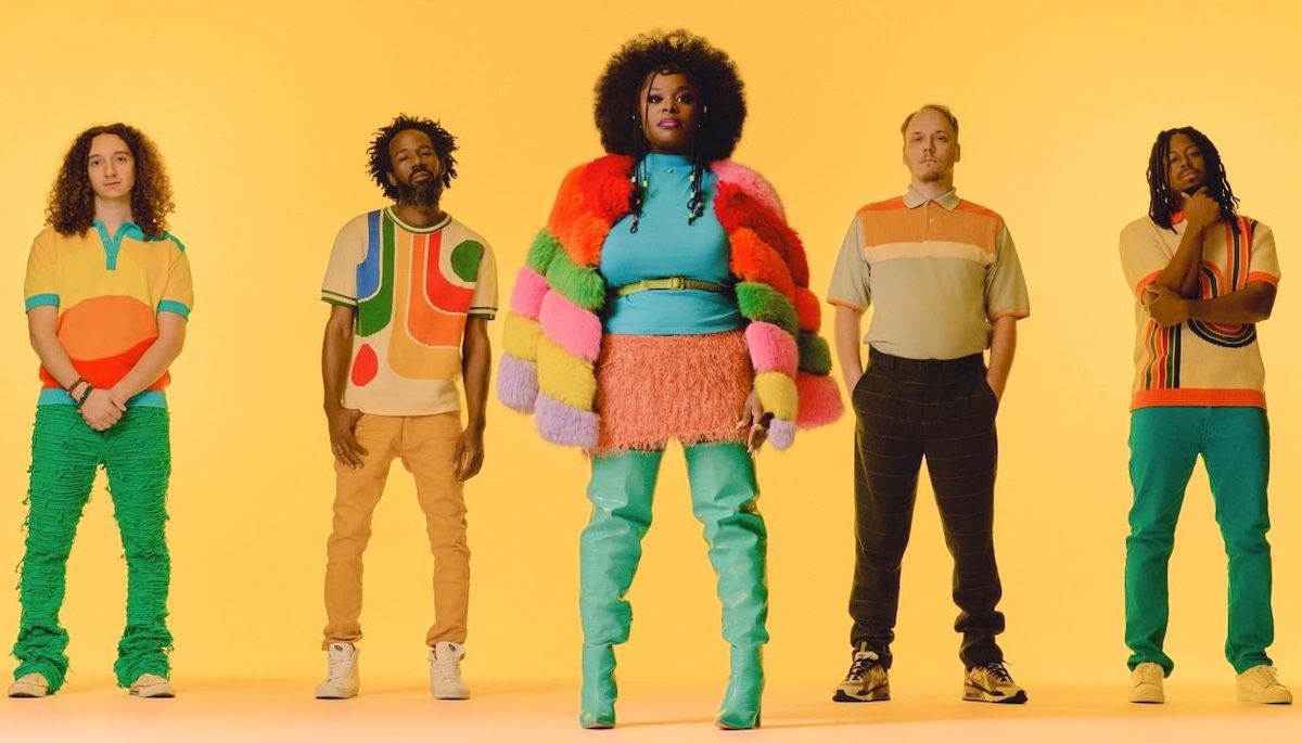 Five fashion models pose against a yellow background in bright, colorful outfits.