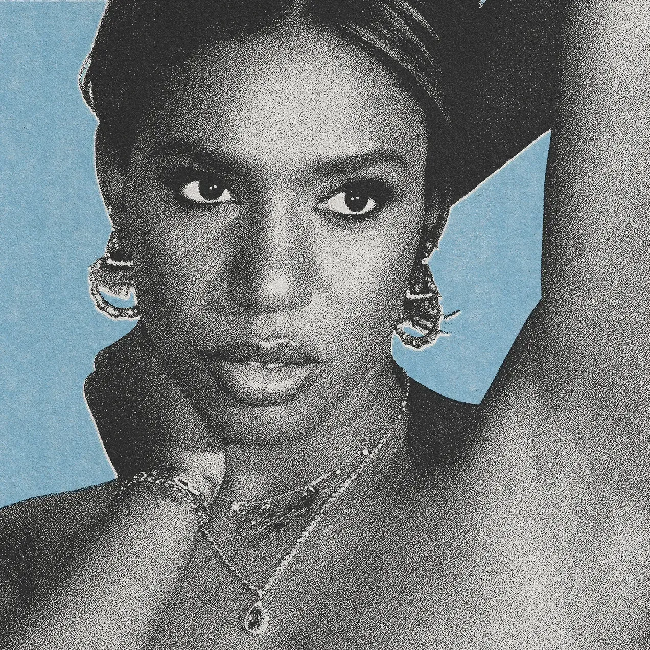 Close-up portrait of a person with hoop earrings, hand near chin, against a blue background.