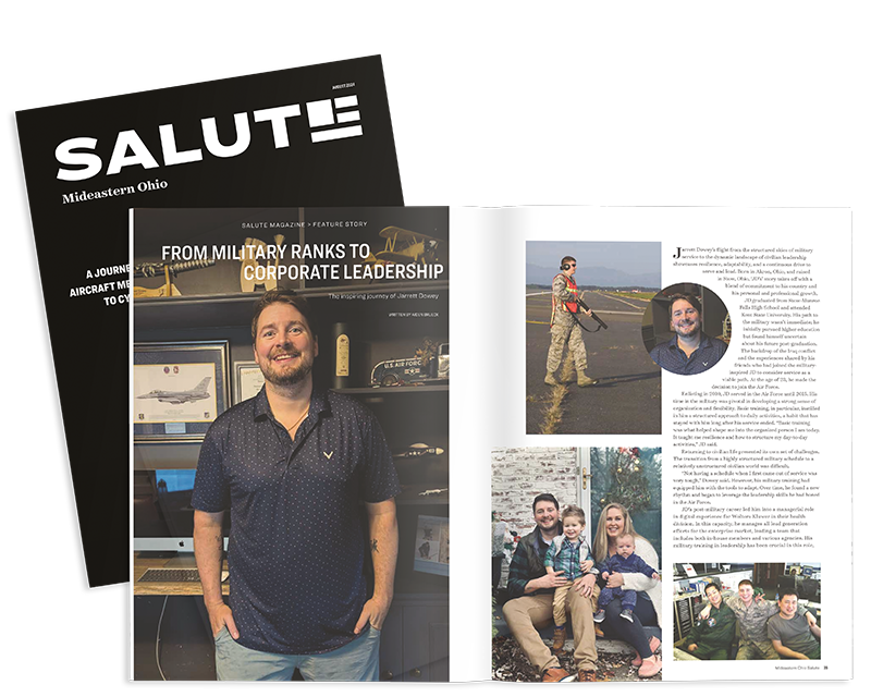 A man is standing next to a magazine that says salute.
