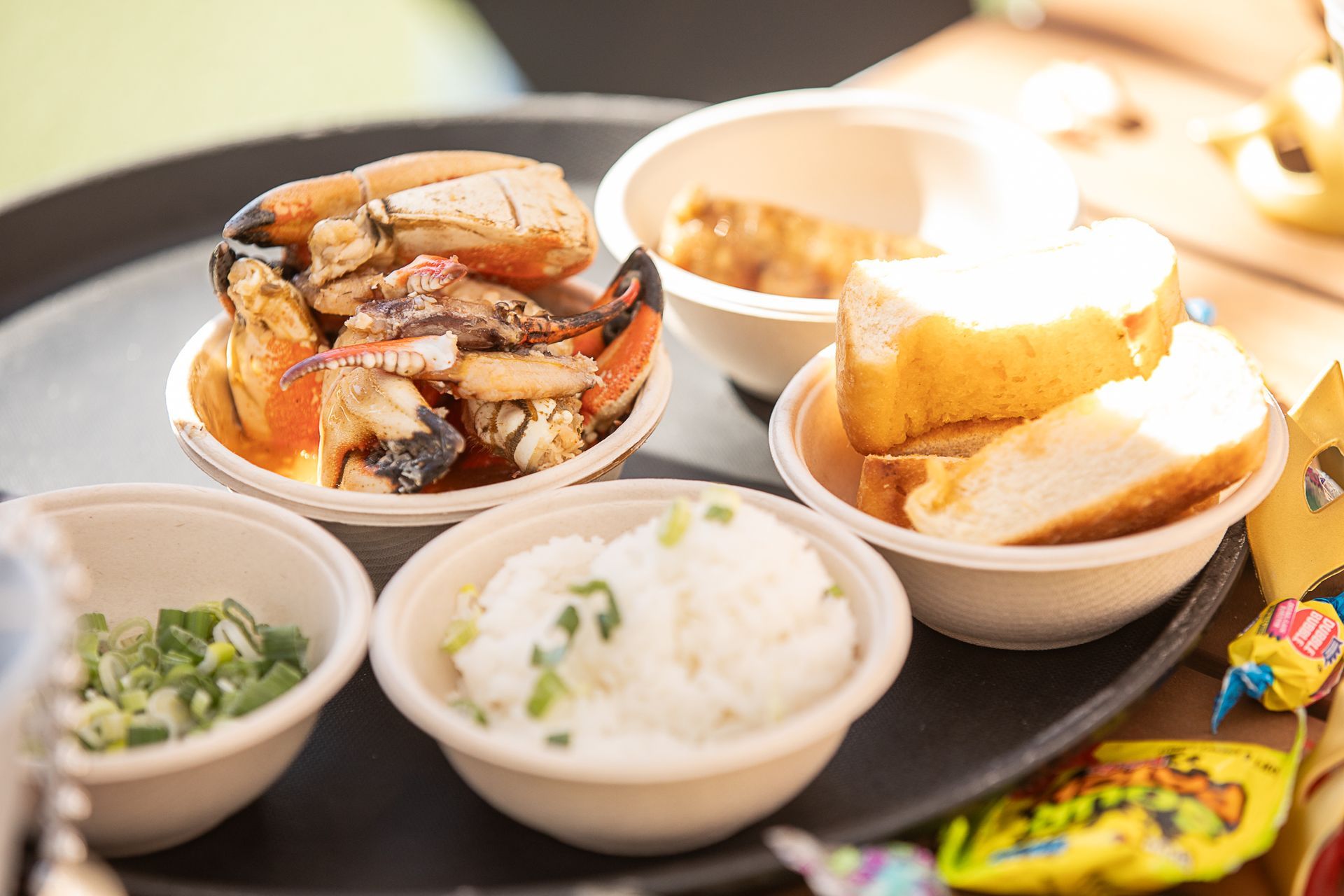 Assortment of ingredients for a seafood gumbo including rice, crab, green onion