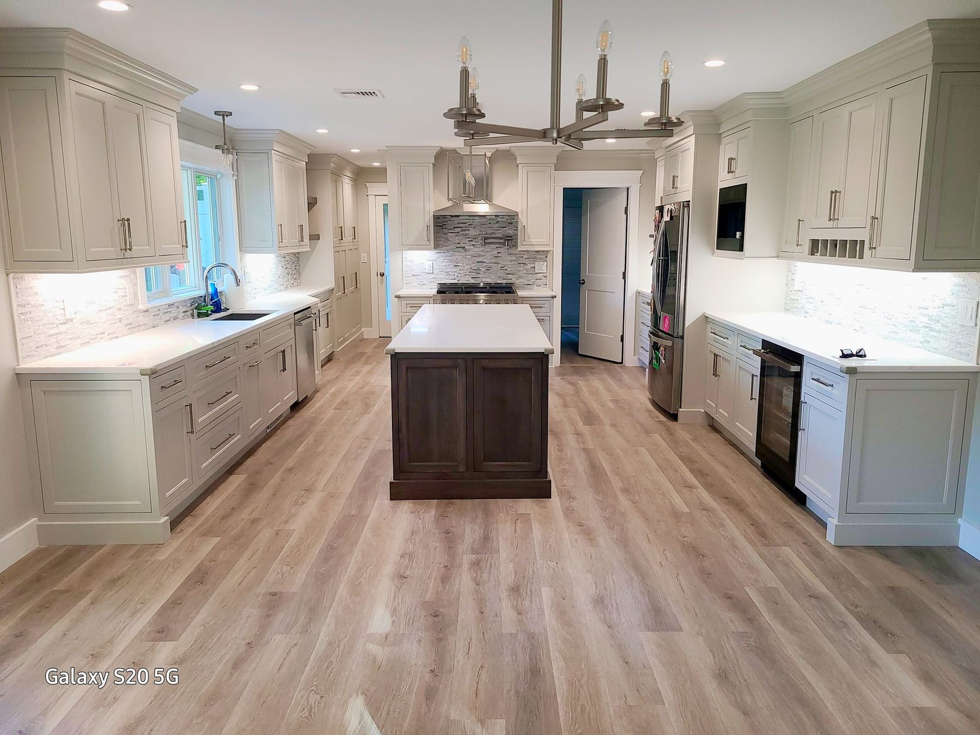 A large kitchen with a large island in the middle