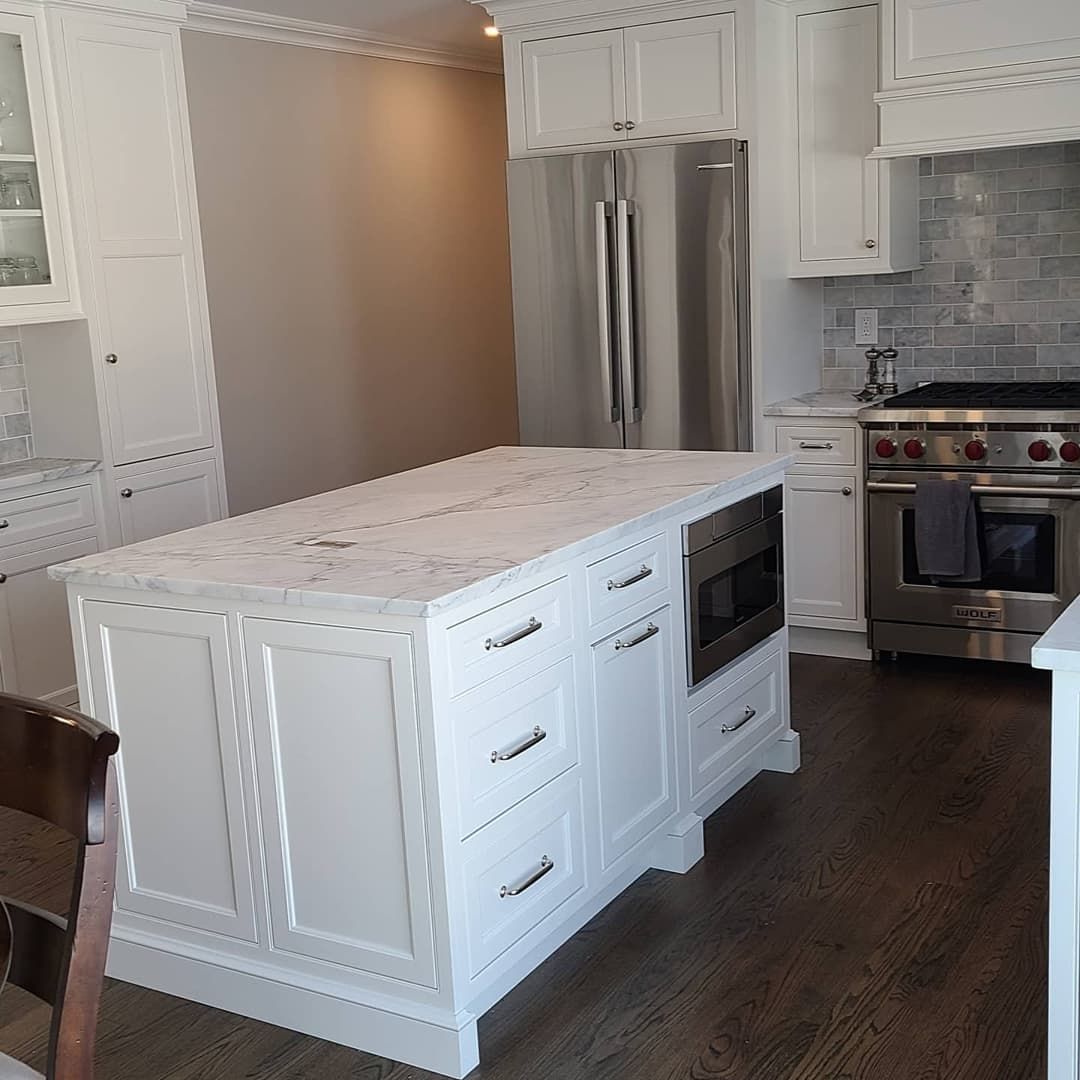 There is a large island in the middle of the kitchen.