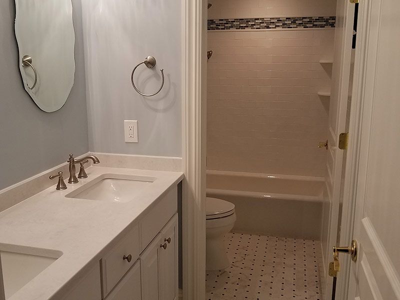 A bathroom with a sink a toilet and a bathtub