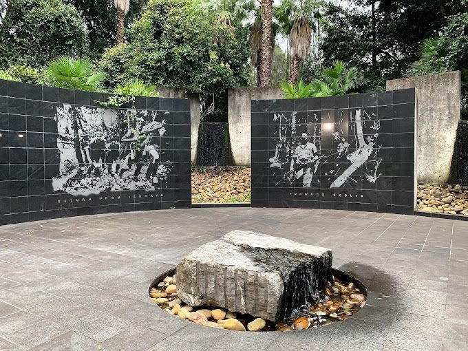 Kokoda Memorial space with steel artworks and stone fire pit in the middle.