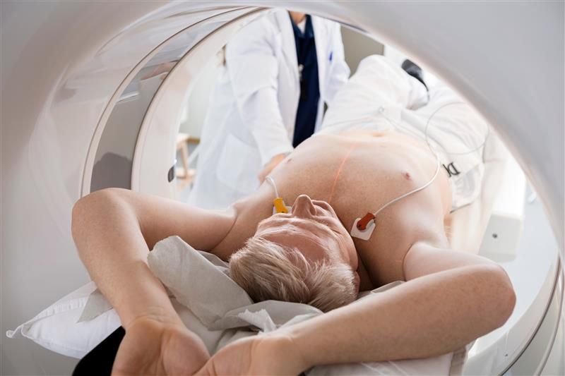 A man is getting a heart CT scan. A man is getting a heart CT scan.