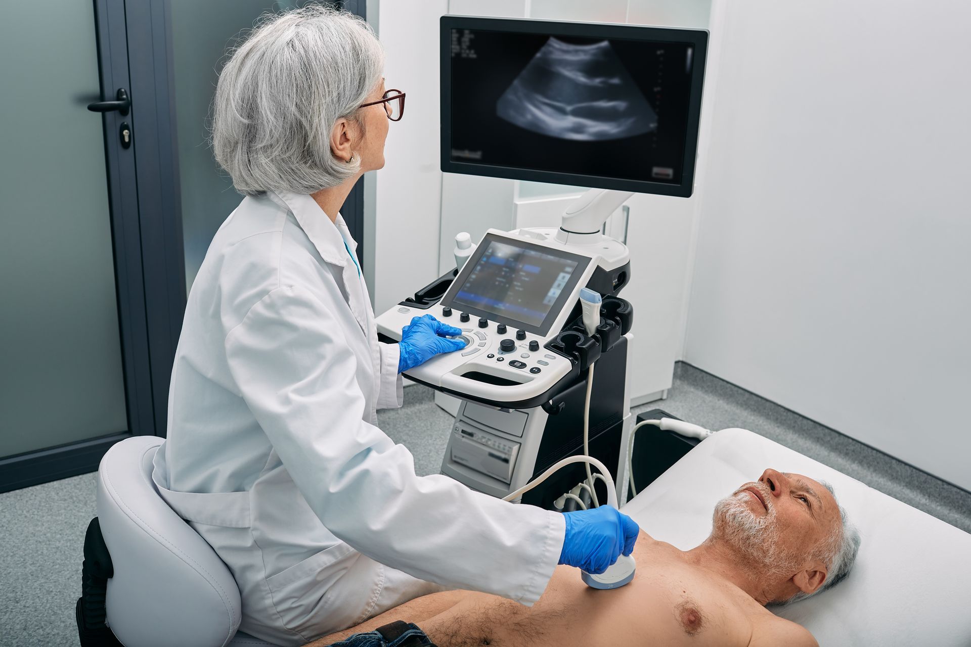 A healthcare professional performing a chest ultrasound using modern diagnostic equipment. A healthcare professional performing a chest ultrasound using modern diagnostic equipment.