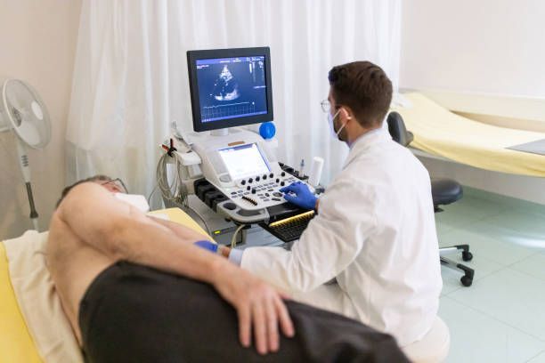 A doctor is doing a heart scan on a patient.