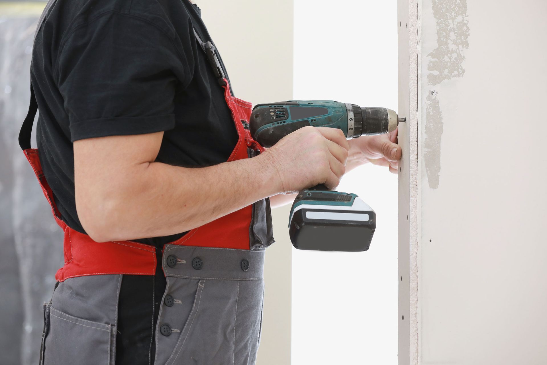 Worker Using An Electric Screwdriver — Rockland County — A+ Garage Door Service