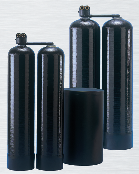 Two water softener tanks with digital control heads and visible plumbing connections.