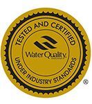 Gold circular Water Quality certification seal with black border and test tube icon, reading 