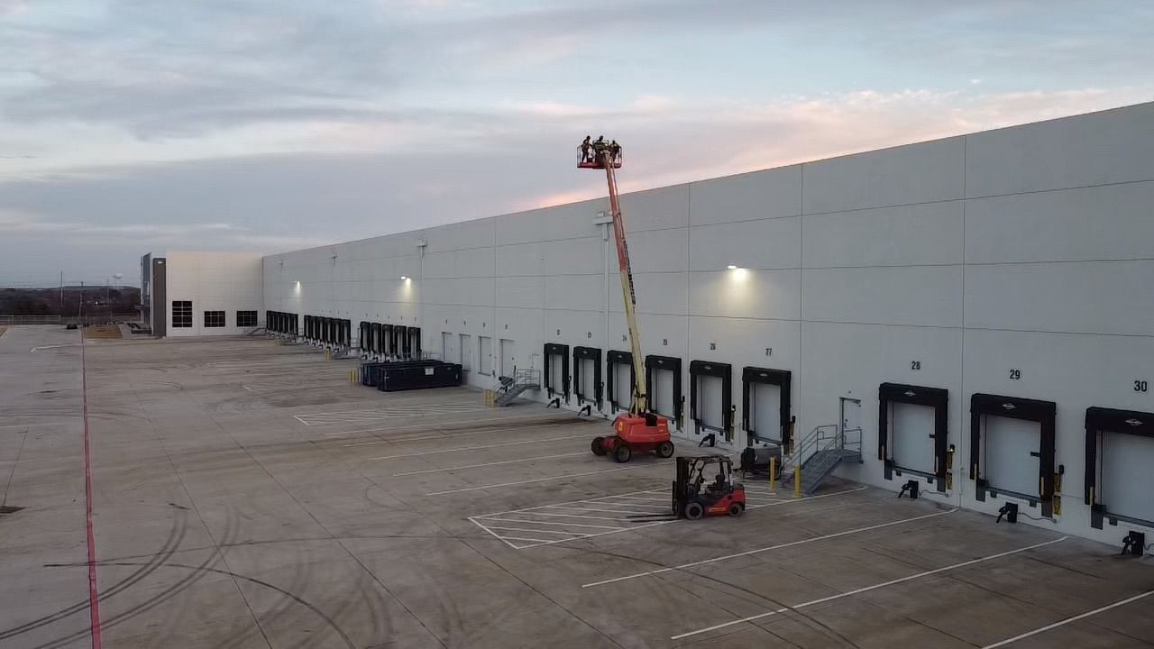 An aerial view of a large white building under construction.