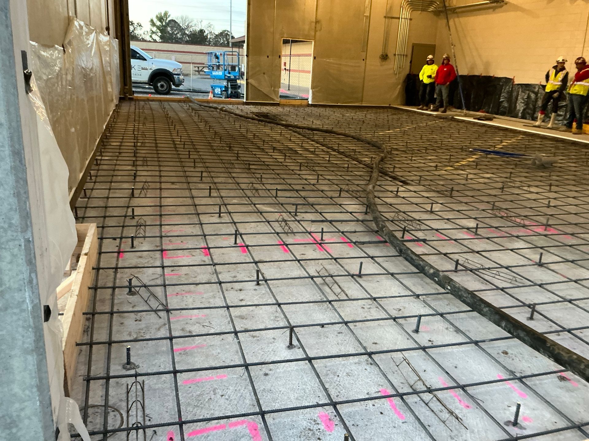 A concrete floor is being built in a building.