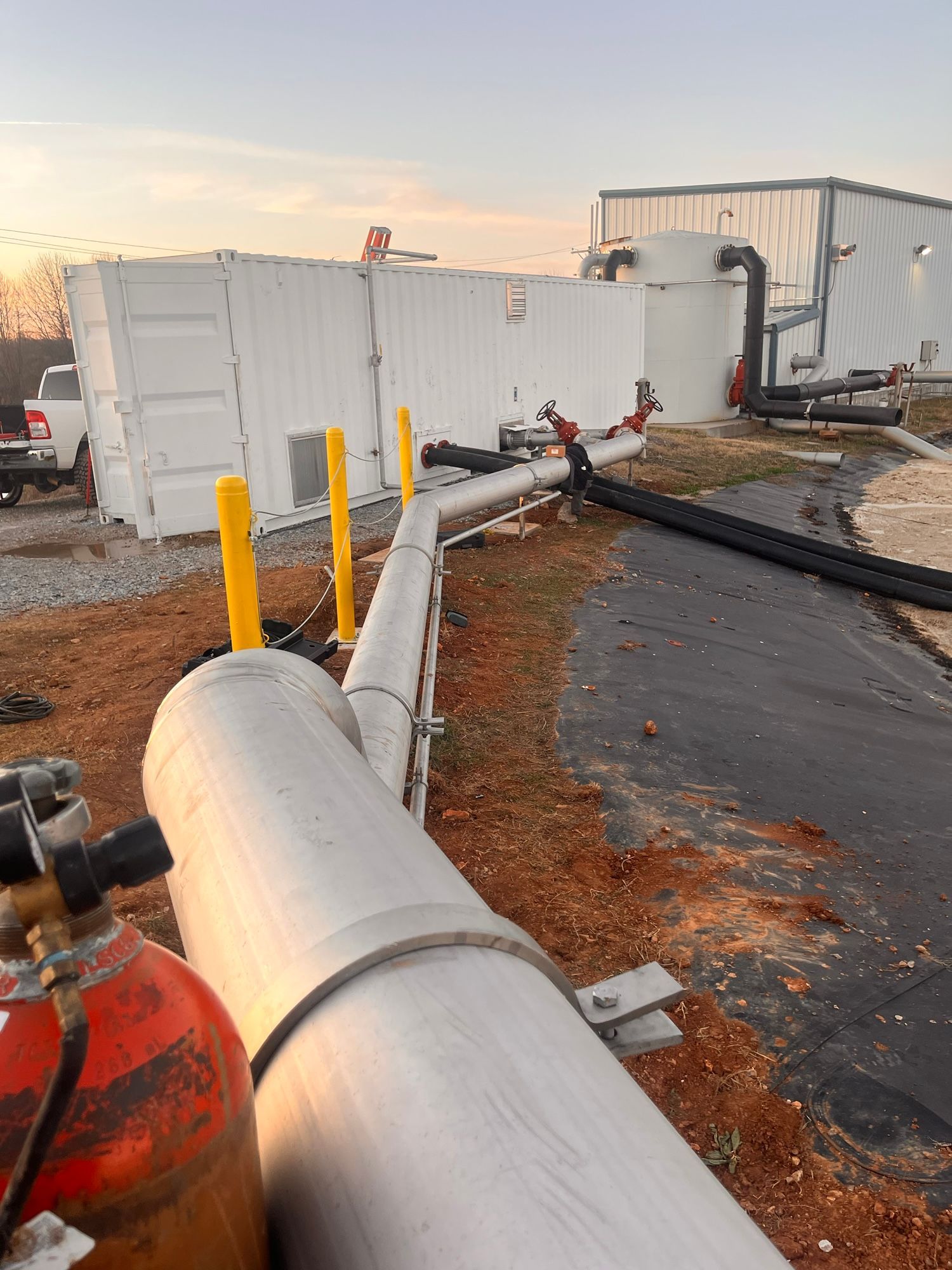 A bunch of pipes are sitting in front of a building.