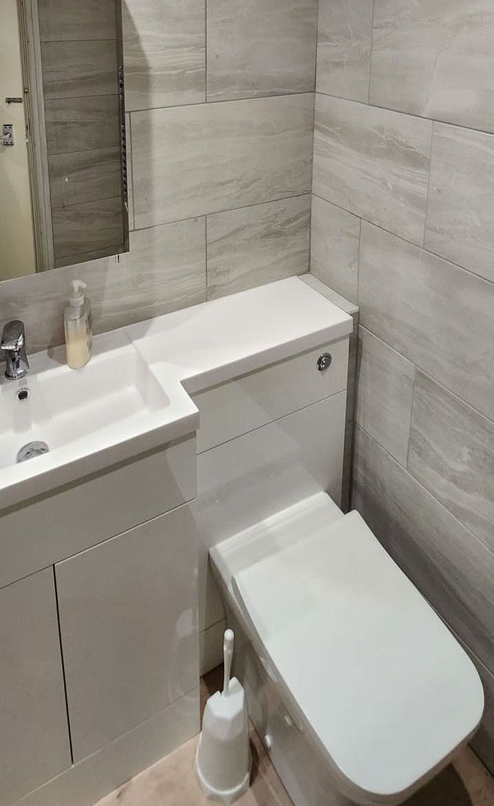 Wonder white bathroom with large grey wall tiles