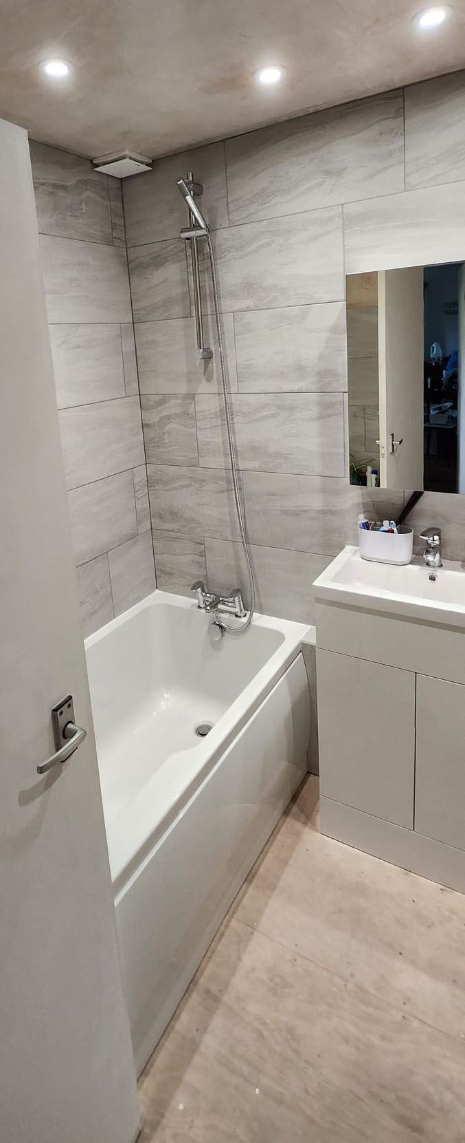 Modern white bathroom with grey tiles