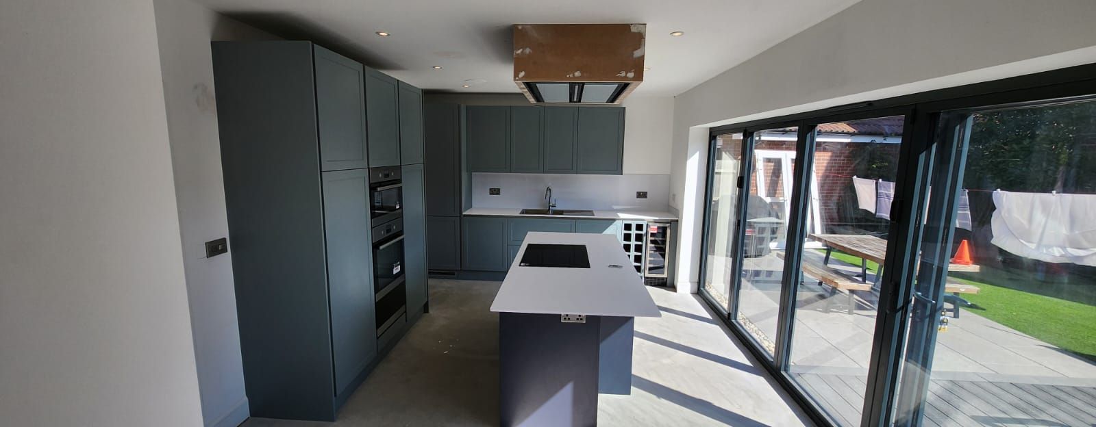 Modern grey handleless kitchen with large island