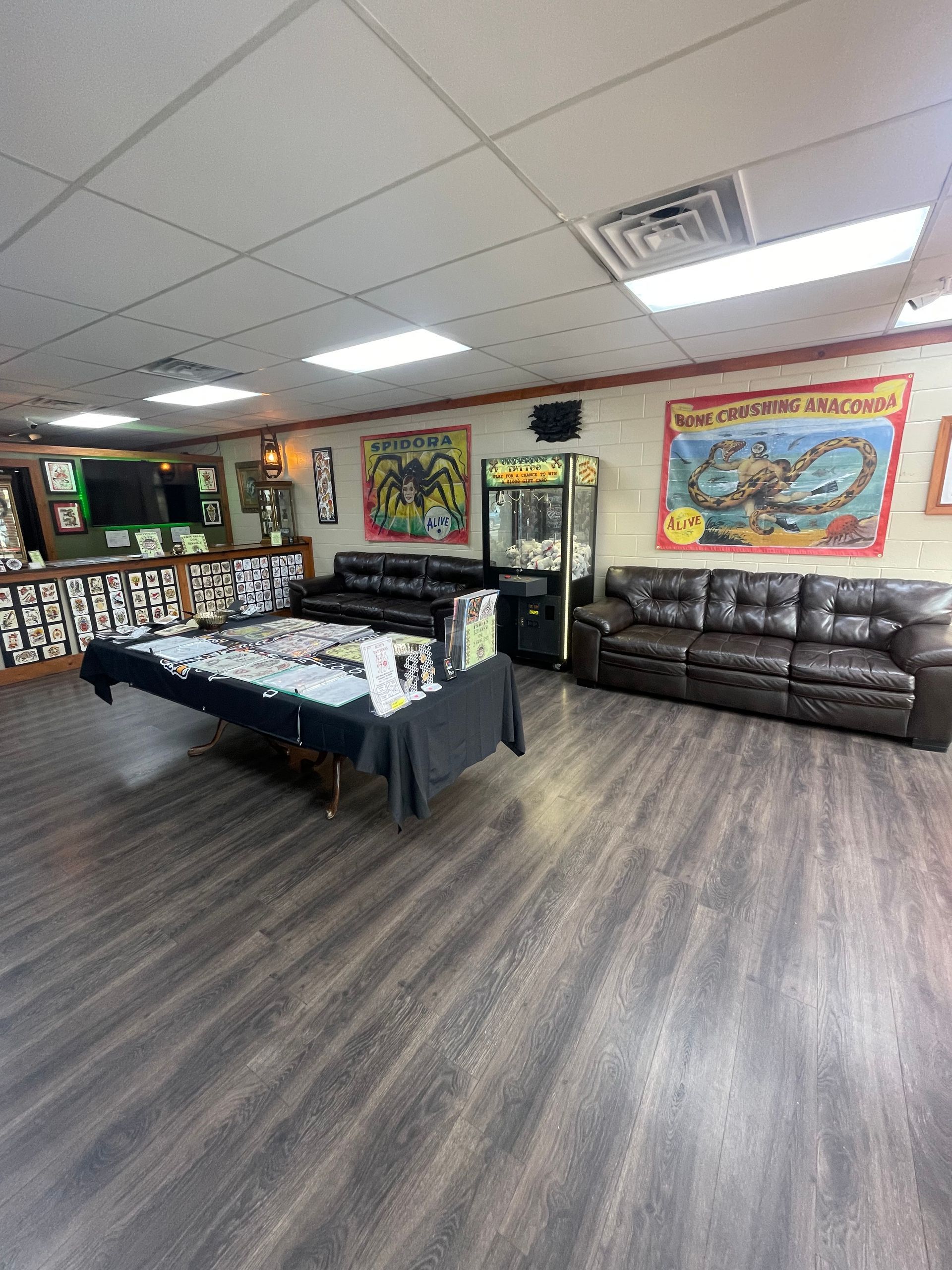 Spacious game room with pool table, couch, wall art, and wood-look flooring