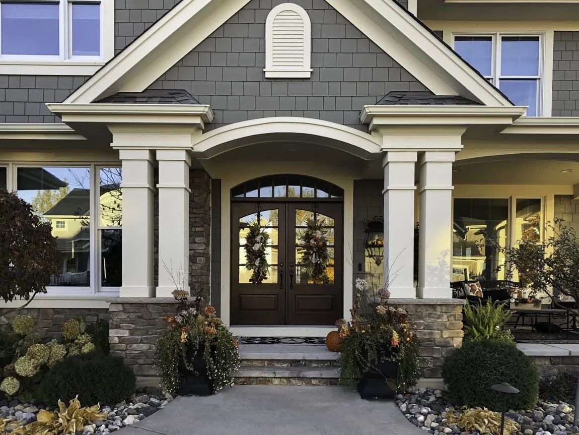 The front door of a house with a gray roof
