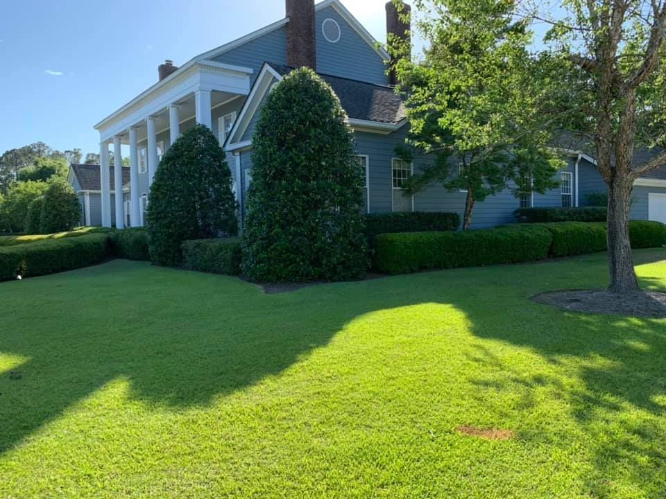 A large house with a large lawn in front of it.