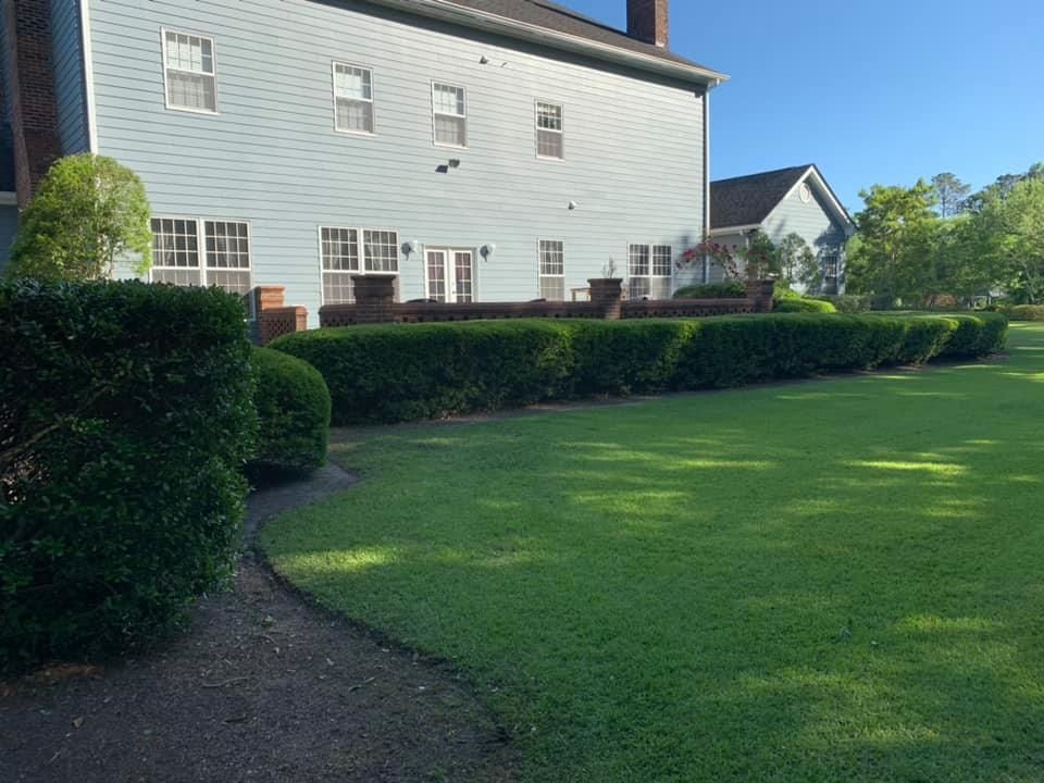 A large house with a lush green lawn in front of it