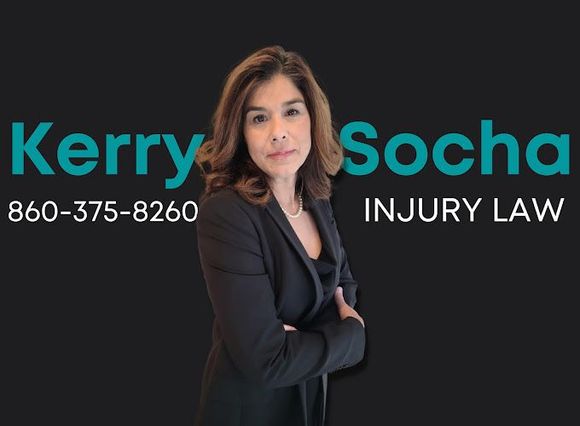 Kerry Socha, Injury Law. Woman in blazer, arms crossed, phone number on black background.