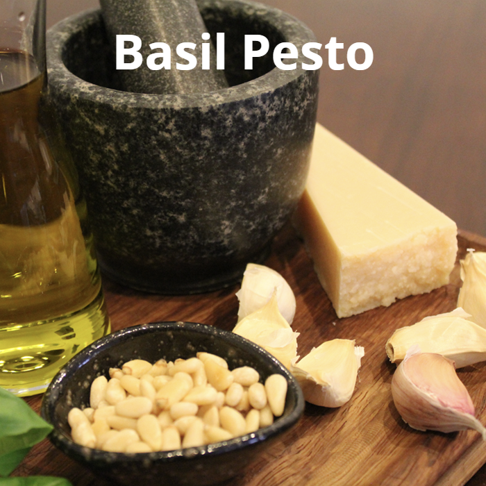 Vibrant green basil pesto made from fresh basil leaves, pine nuts, garlic, sea salt flakes, black pepper, Parmesan cheese, and extra virgin olive oil.