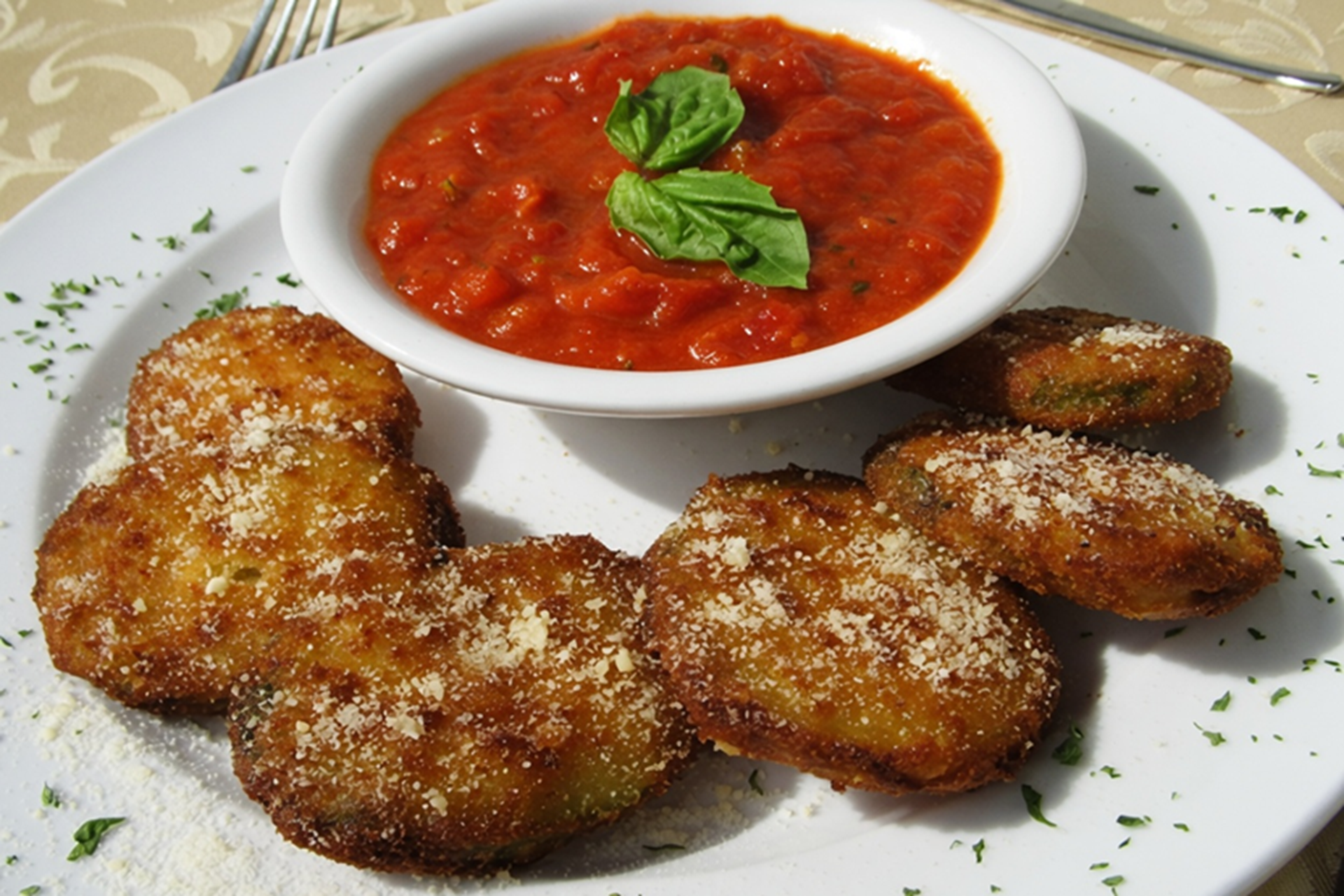 Golden fried zucchini served with marinara dipping sauce.